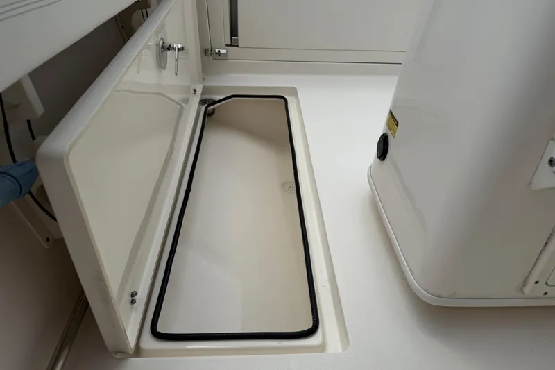 Slide: The Image of 2022 Cobia 240 Center Console boat storage compartment detail. - 21