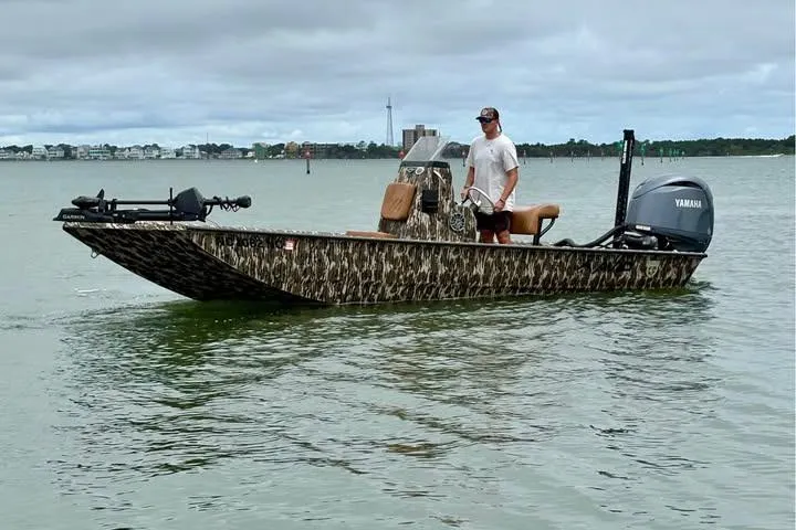 Slide: The Image of 2024 Avid 20 Rogue boat with Yamaha motor on calm water. - 0