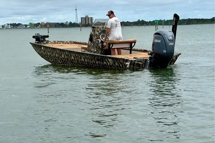 Slide: The Image of 2024 Avid 20 Rogue boat with Yamaha 150 engine on calm water. - 2