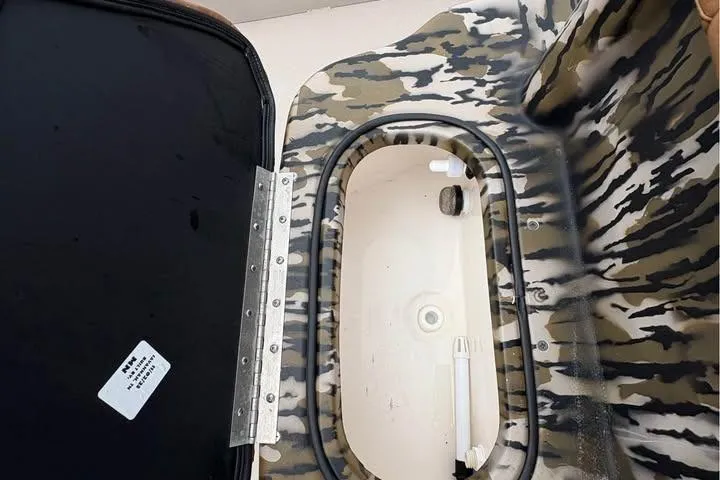 Slide: The Image of Open storage compartment in camo design, Avid 20 Rogue 2024 model. - 6