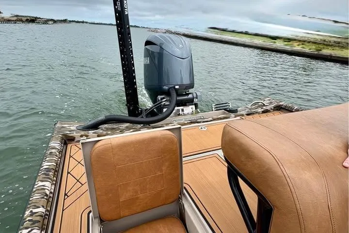 Slide: The Image of 2024 Avid 20 Rogue boat with Yamaha motor on a calm waterway. - 8