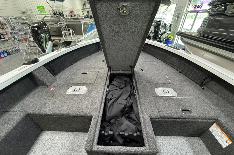 Slide: The Image of 2025 Crestliner 1850 Pro Tiller boat interior with open storage compartment. - 10