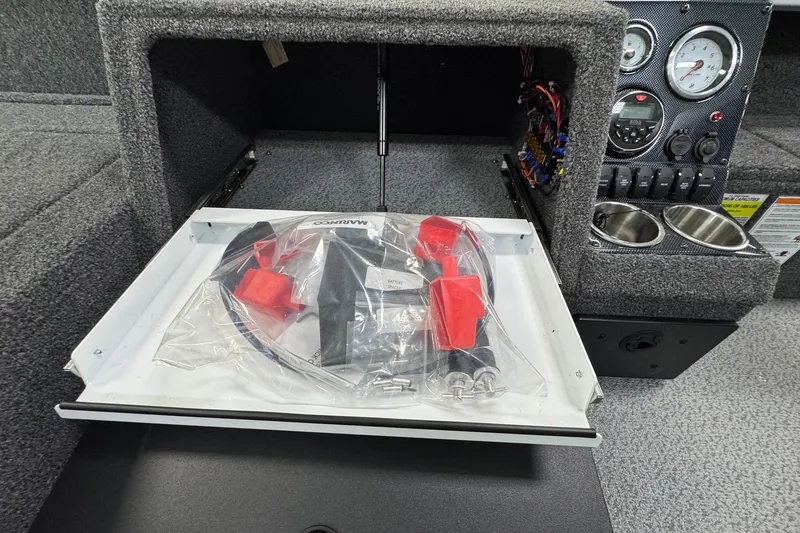 Slide: The Image of 2025 Crestliner 1850 Pro Tiller dashboard with gauges and storage compartment. - 14