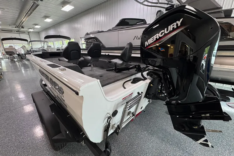 Slide: The Image of 2025 Crestliner 1850 Pro Tiller boat with Mercury engine in showroom. - 2