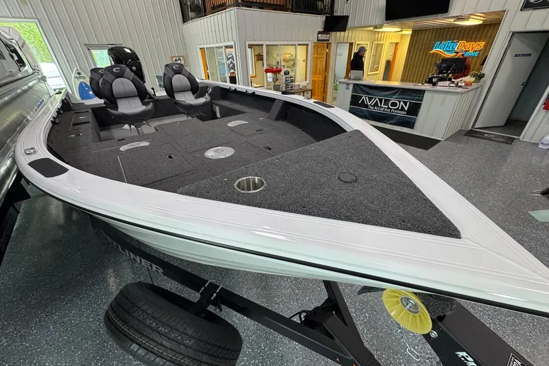 Slide: The Image of 2025 Crestliner 1850 Pro Tiller boat displayed indoors, featuring spacious seating and modern design. - 5