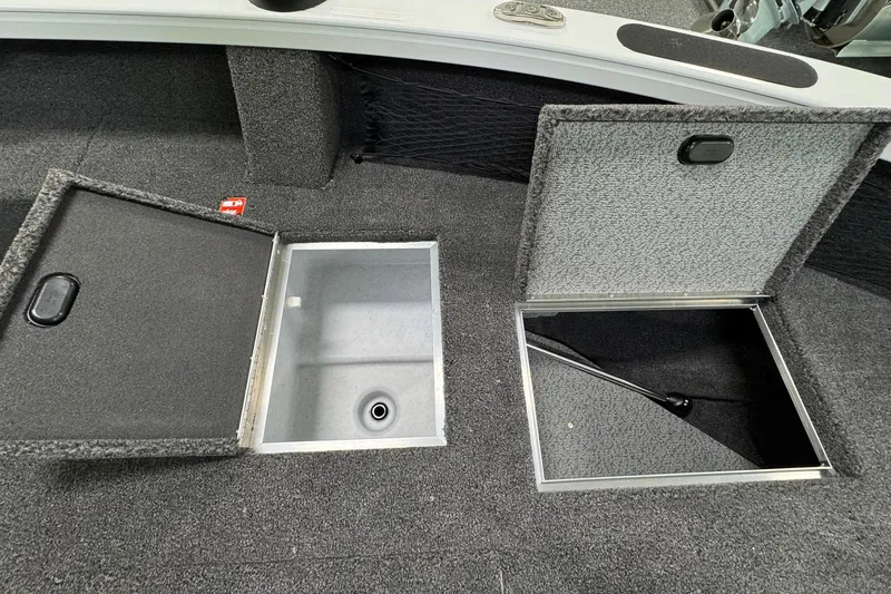 Slide: The Image of 2025 Crestliner 1850 Pro Tiller boat storage compartments with open lids, showcasing interior space. - 8