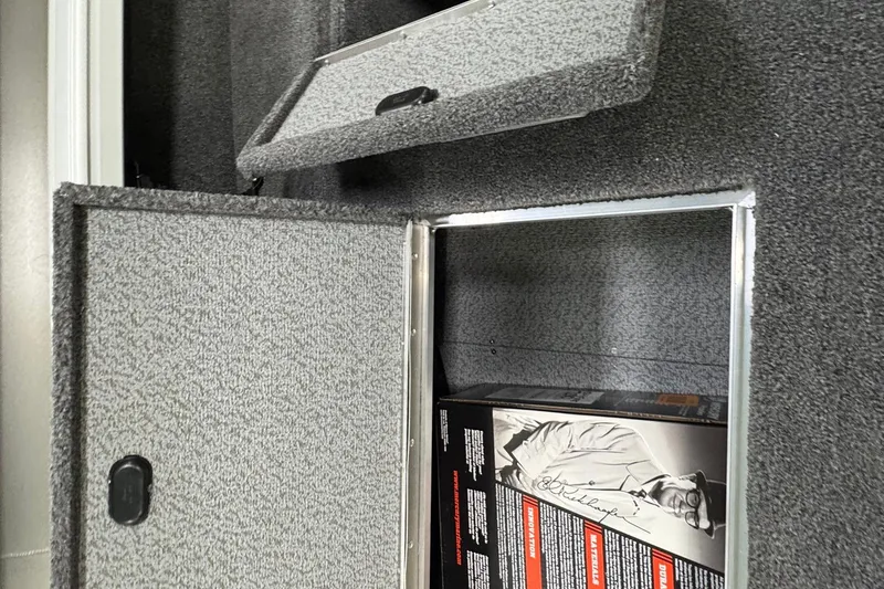 Slide: The Image of Open storage compartment in 2025 Crestliner 1850 Pro Tiller boat, showing interior details. - 9