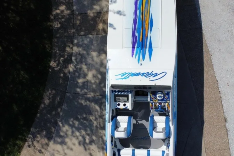 Slide: The Image of Overhead view of 2001 Cigarette 38 Top Gun boat with colorful graphics. - 10