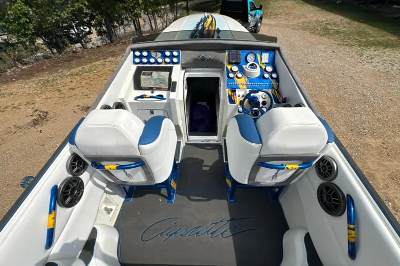Slide: The Image of 2001 Cigarette 38 Top Gun boat interior with blue and white seating, dashboard, and controls. - 14