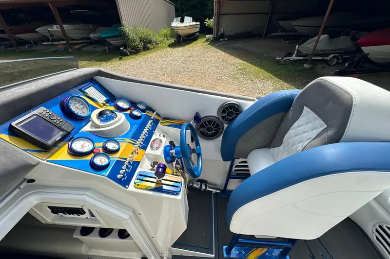 Slide: The Image of 2001 Cigarette 38 Top Gun boat cockpit with blue and white seating, gauges, and controls. - 17