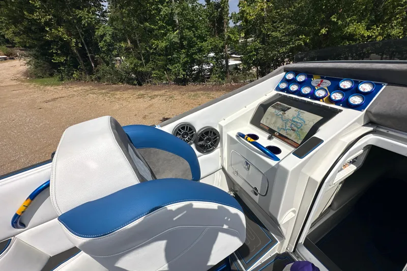 Slide: The Image of 2001 Cigarette 38 Top Gun boat cockpit with blue and white seating, dashboard, and navigation system. - 19