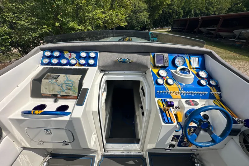 Slide: The Image of 2001 Cigarette 38 Top Gun boat cockpit with vibrant blue and yellow dashboard controls. - 22