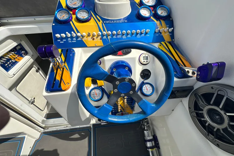 Slide: The Image of 2001 Cigarette 38 Top Gun boat dashboard with blue steering wheel and gauges. - 23