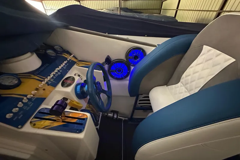 Slide: The Image of 2001 Cigarette 38 Top Gun cockpit with blue accents and illuminated controls. - 26