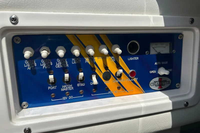 Slide: The Image of Control panel of a 2001 Cigarette 38 Top Gun boat with various switches and gauges. - 30