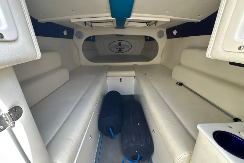 Slide: The Image of Interior of a 2001 Cigarette 38 Top Gun boat with white seating and storage. - 31