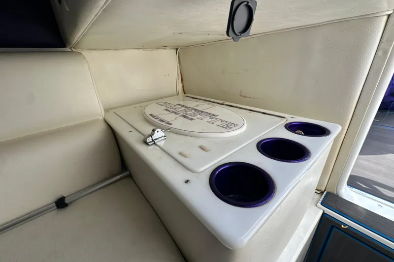 Slide: The Image of 2001 Cigarette 38 Top Gun boat interior with cup holders and storage compartment. - 35