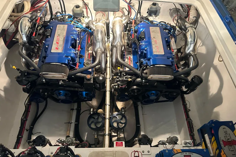 Slide: The Image of 2001 Cigarette 38 Top Gun boat engine compartment with dual blue engines. - 44