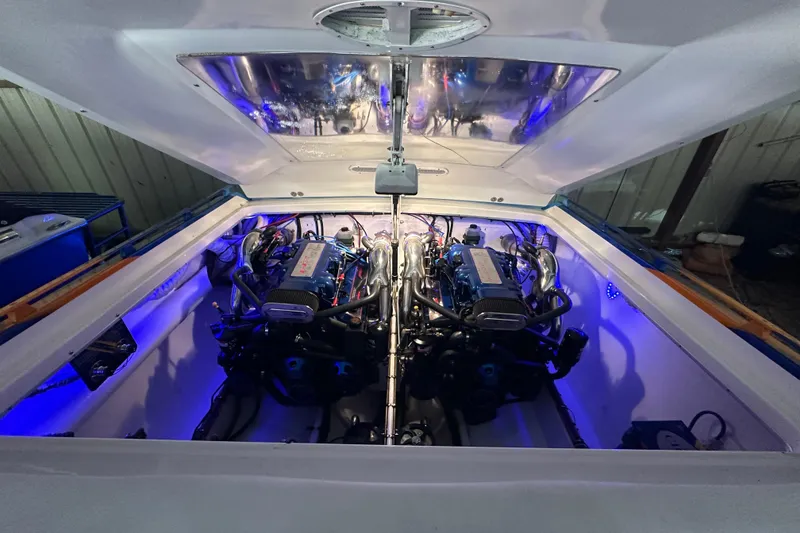 Slide: The Image of Engine compartment of a 2001 Cigarette 38 Top Gun boat with blue lighting. - 47