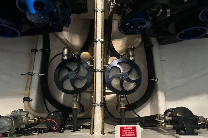 Slide: The Image of Engine compartment of a 2001 Cigarette 38 Top Gun boat, featuring mechanical components. - 49