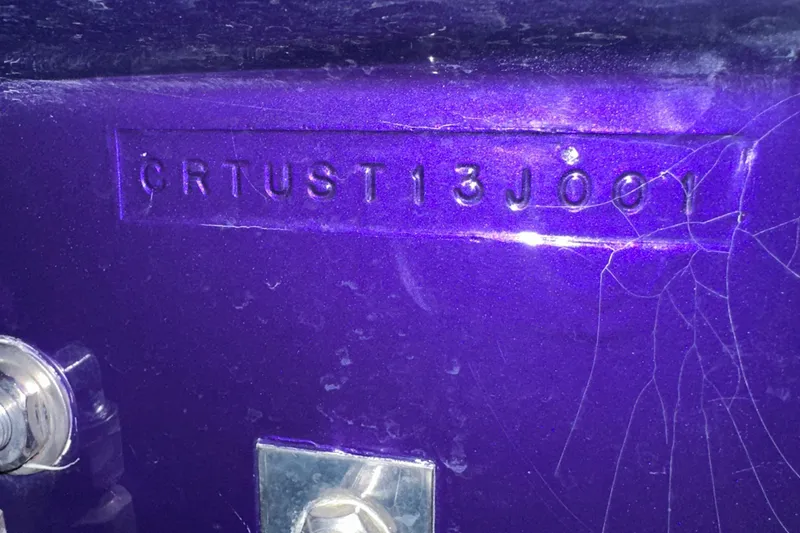 Slide: The Image of 2001 Cigarette 38 Top Gun hull identification number on purple surface. - 55