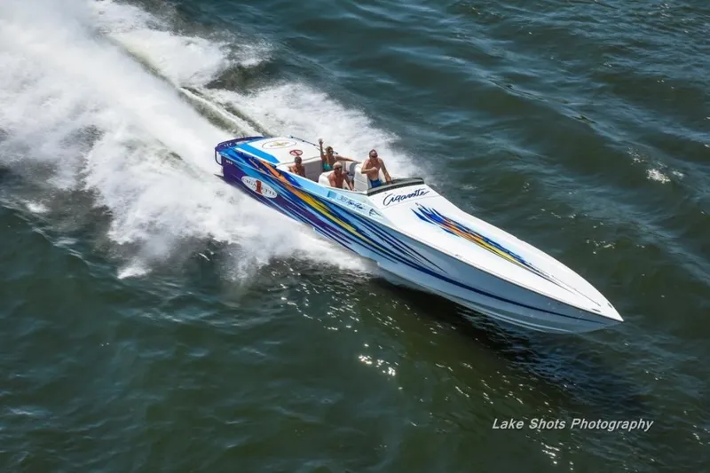 Slide: The Image of 2001 Cigarette 38 Top Gun speedboat racing on open water, vibrant graphics, aerial view. - 7