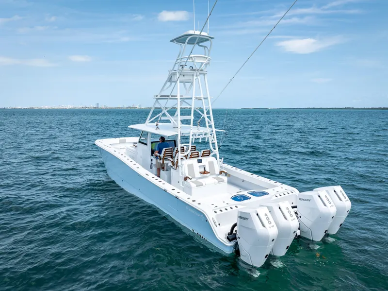 Slide: The Image of 2024 Freeman NEW QUAD V10s 400 HP boat cruising on open water. - 18