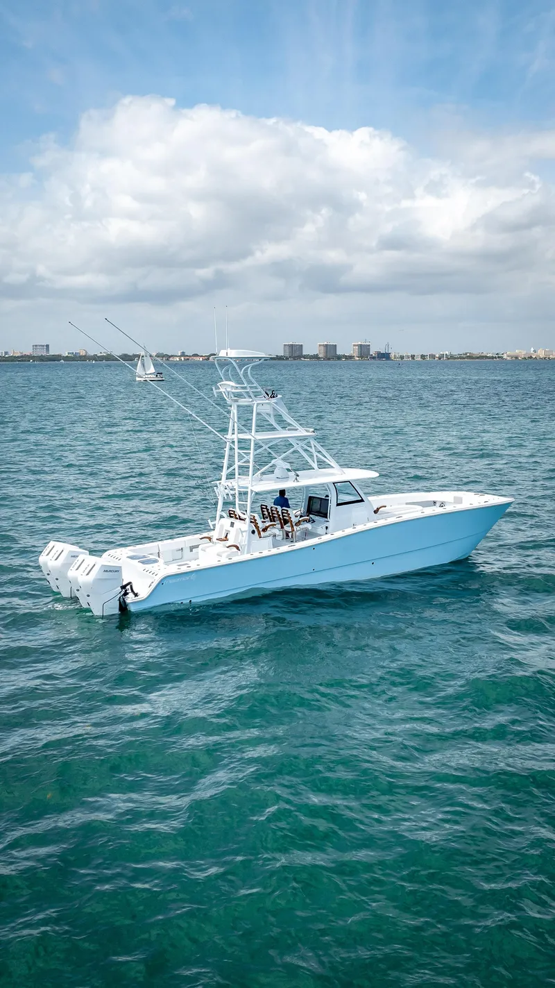 Slide: The Image of 2024 Freeman NEW QUAD V10s 400 HP boat cruising on the ocean. - 2