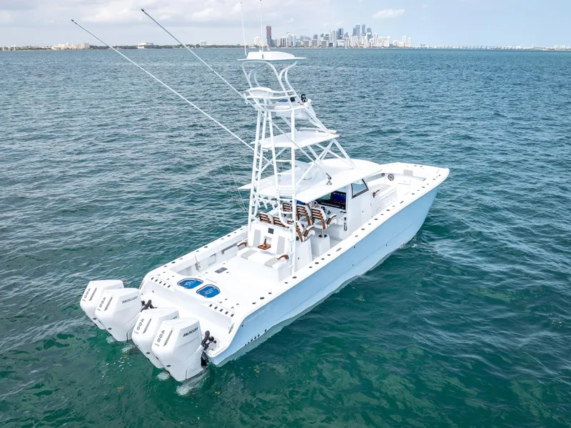 Slide: The Image of 2024 Freeman NEW QUAD V10s 400 HP boat on open water with city skyline. - 24