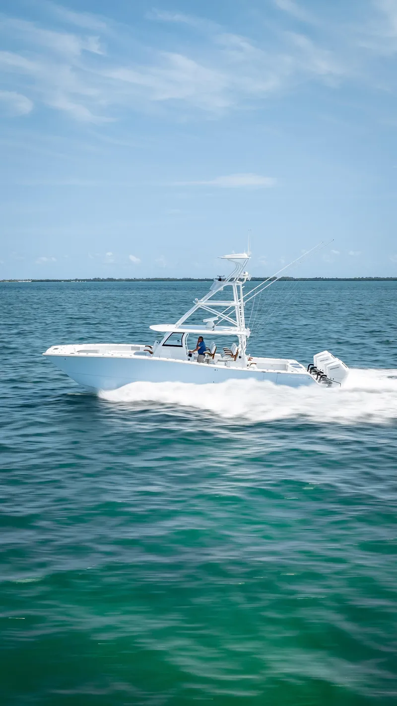 Slide: The Image of 2024 Freeman NEW QUAD V10s 400 HP boat cruising on open water. - 37