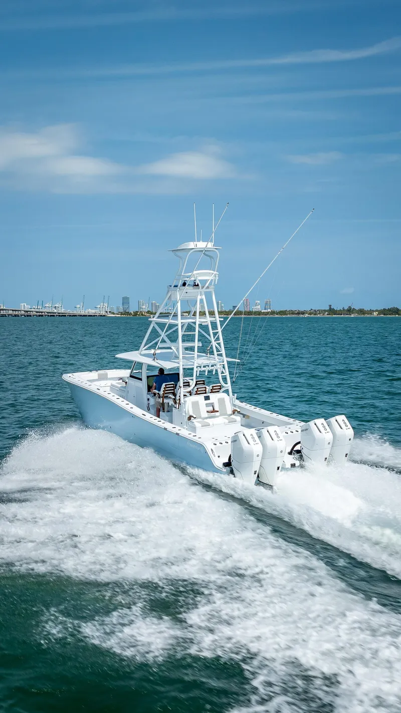 Slide: The Image of Freeman NEW 2024 boat with Quad V10s 400 HP engines cruising on open water. - 44