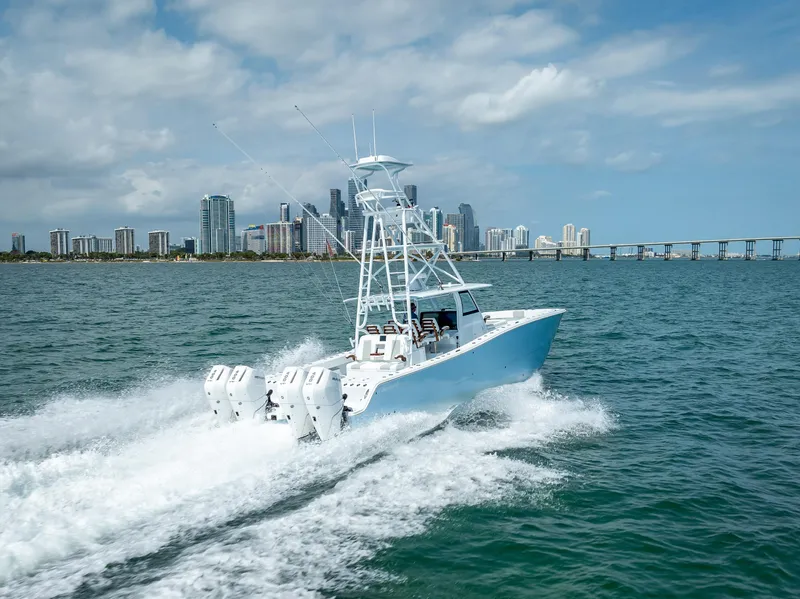 Slide: The Image of 2024 Freeman boat with quad V10 400 HP engines cruising near city skyline. - 47