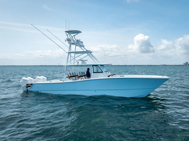 Slide: The Image of 2024 Freeman NEW QUAD V10s 400 HP boat cruising on open water. - 6