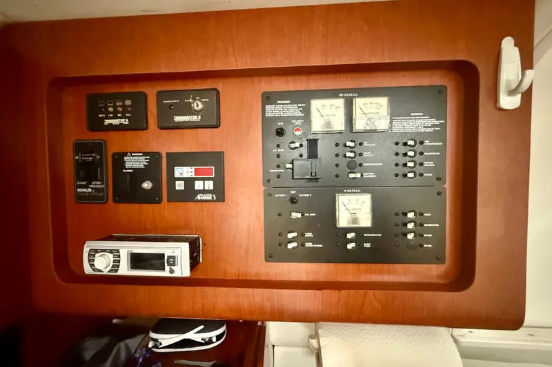 Slide: The Image of Control panel of a 2006 Pro-Line 32 Express boat, featuring various switches and gauges. - 14