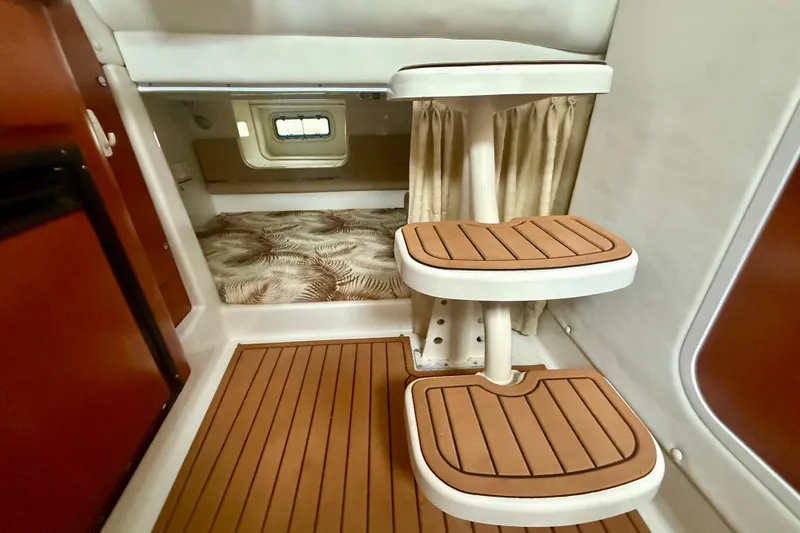 Slide: The Image of 2006 Pro-Line 32 Express cabin interior with wooden steps and patterned bedding. - 18