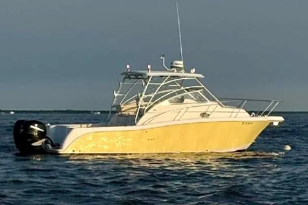 Slide: The Image of 2006 Pro-Line 32 Express boat on calm water at sunset. - 2