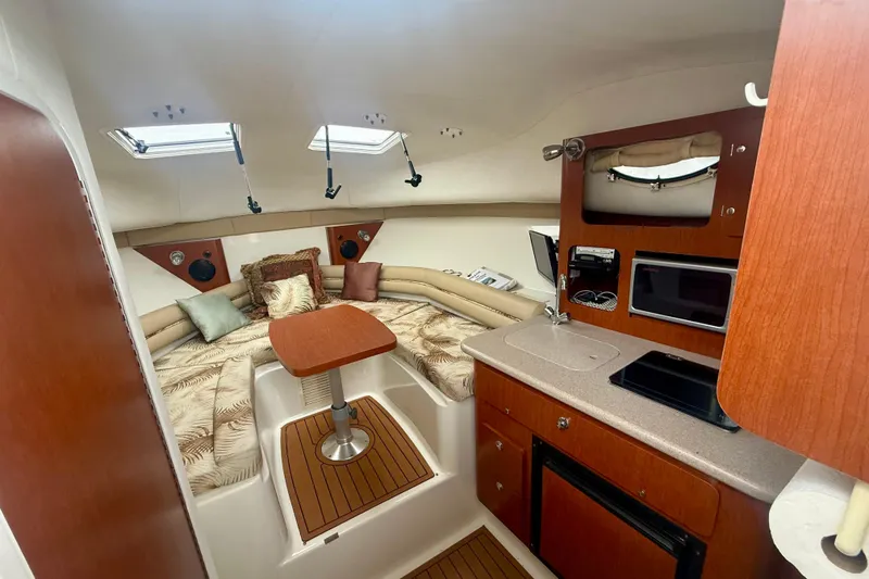 Slide: The Image of 2006 Pro-Line 32 Express cabin interior with kitchenette, seating, and skylights. - 23