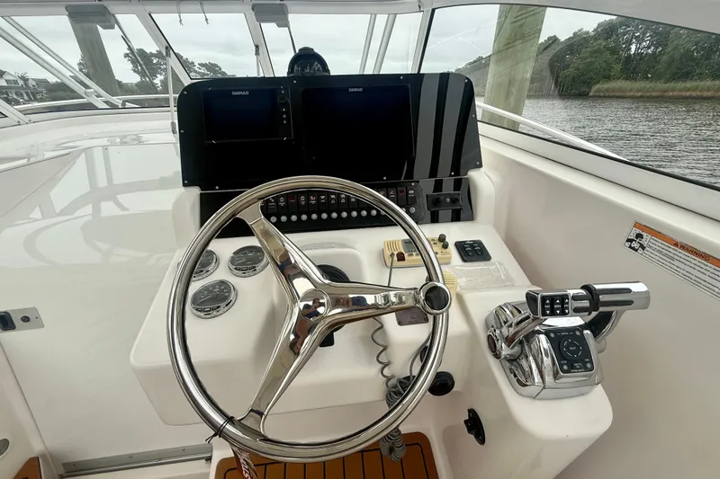 Slide: The Image of 2006 Pro-Line 32 Express boat helm with steering wheel and control panel. - 26