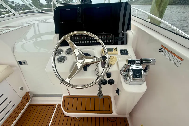 Slide: The Image of Helm of 2006 Pro-Line 32 Express boat with steering wheel and controls. - 28