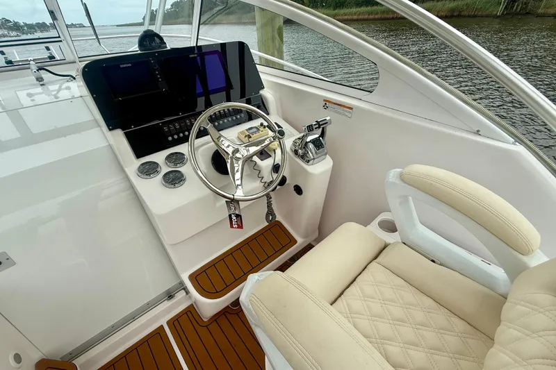 Slide: The Image of Helm of 2006 Pro-Line 32 Express boat with steering wheel and control panel. - 30