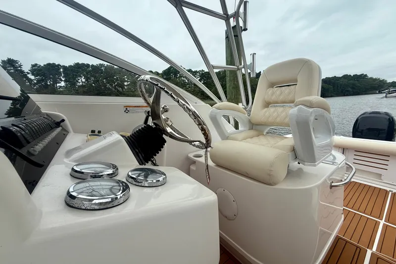 Slide: The Image of 2006 Pro-Line 32 Express boat helm with luxurious seating and polished controls. - 31