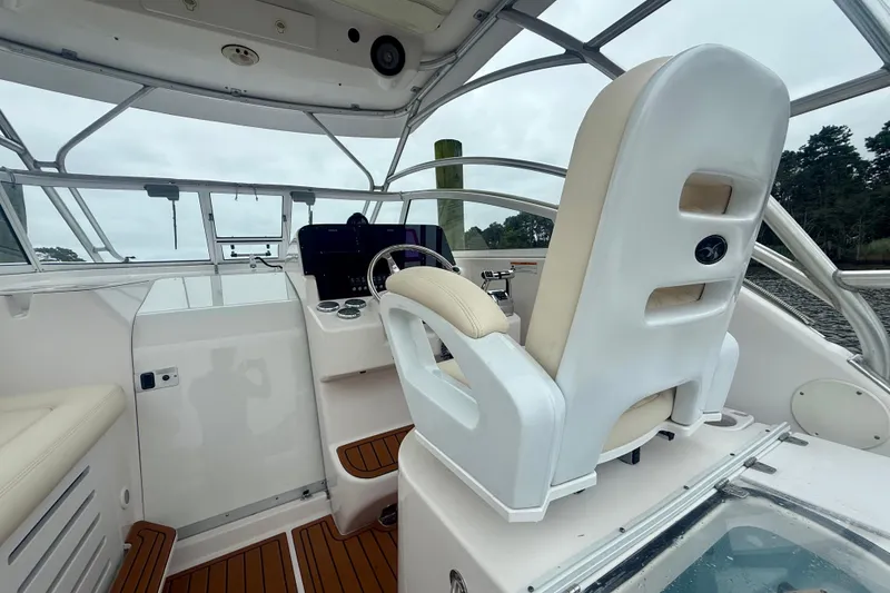 Slide: The Image of 2006 Pro-Line 32 Express boat interior with helm and seating area. - 34