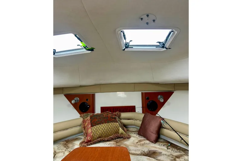 Slide: The Image of Interior cabin of 2006 Pro-Line 32 Express boat with skylights and decorative pillows. - 35