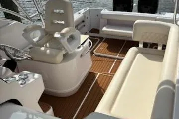 Slide: The Image of 2006 Pro-Line 32 Express boat interior with cushioned seating and wooden flooring. - 4