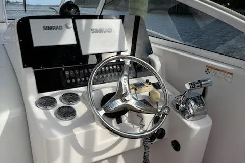 Slide: The Image of 2006 Pro-Line 32 Express boat helm with Simrad electronics and steering wheel. - 7
