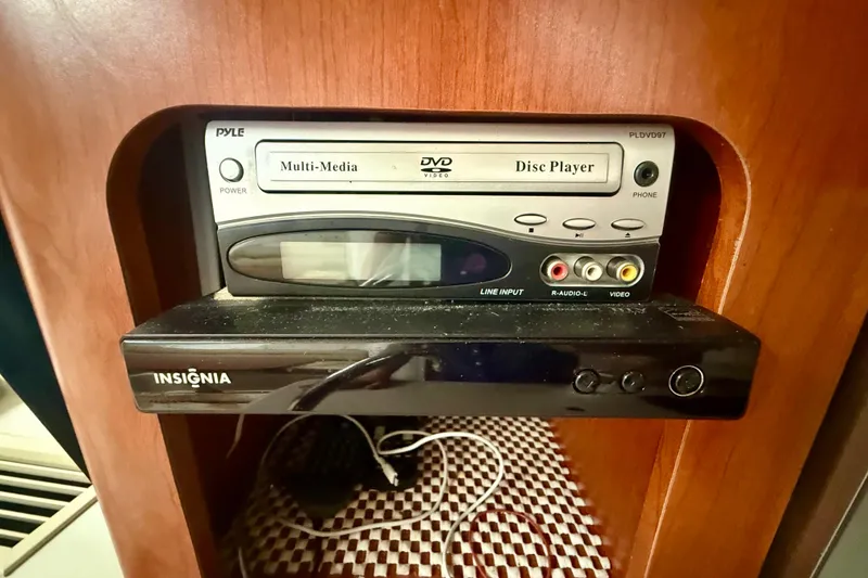 Slide: The Image of DVD and media players in a 2006 Pro-Line 32 Express boat interior. - 8