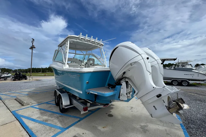 Slide: The Image of 2023 Albemarle 27 Dual Console boat with twin engines on a trailer, parked outdoors. - 11