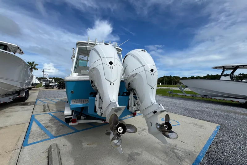 Slide: The Image of 2023 Albemarle 27 Dual Console boat with twin outboard engines, parked on a sunny day. - 12