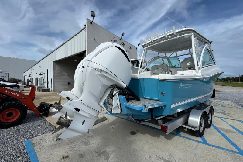 Slide: The Image of 2023 Albemarle 27 Dual Console boat with twin engines on a trailer. - 14