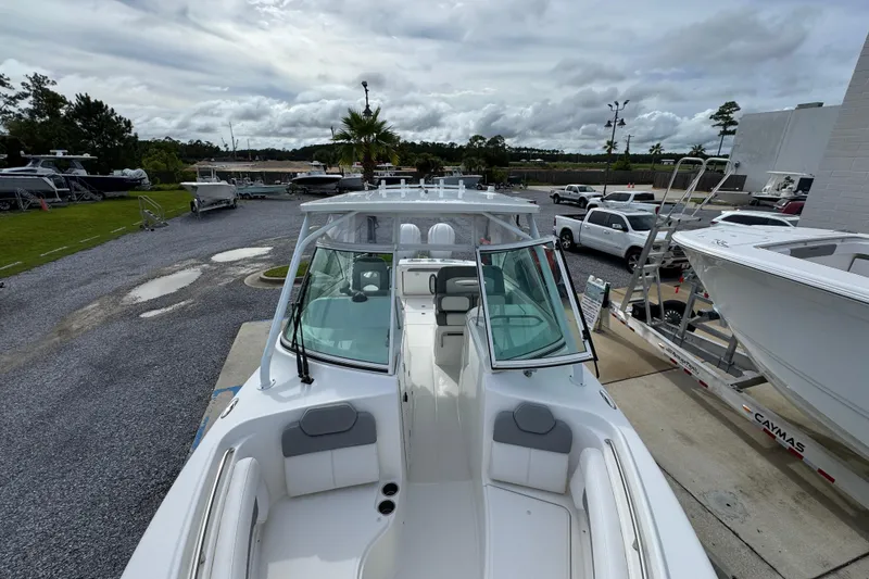 Slide: The Image of 2023 Albemarle 27 Dual Console boat on display at a marina with cloudy skies. - 19